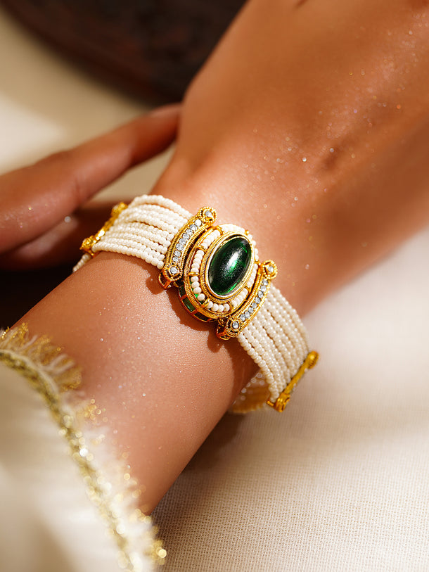 Gold Plated Pearl Beaded Multi Strand Kundan Emerald Centered Bracelet