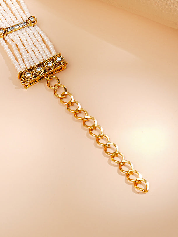Gold Plated Pearl Beaded Multi Strand Kundan Emerald Centered Bracelet