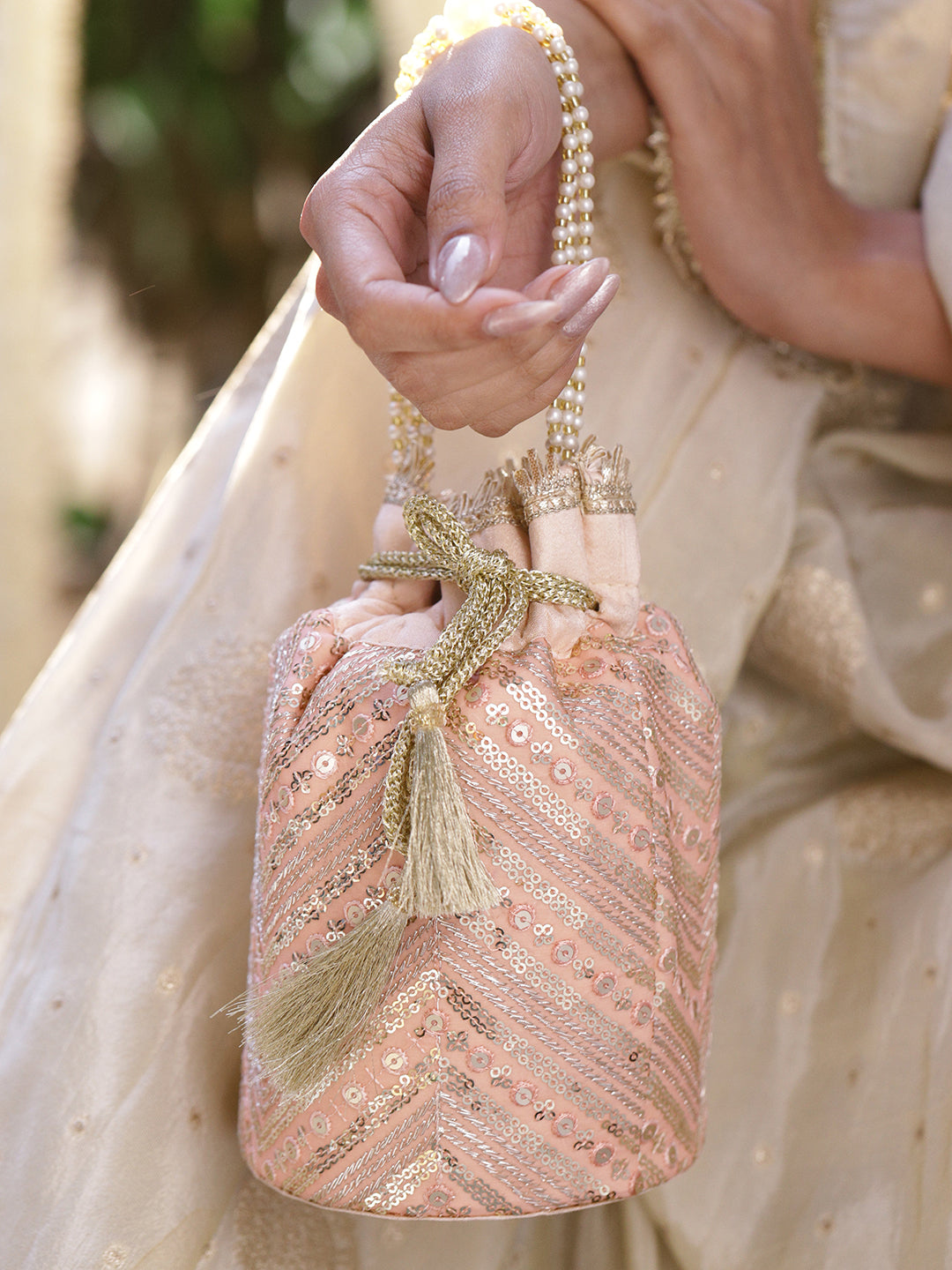 Rubans Peach Pink Sequin Embellished Potli Bag with Pearl Handle & Golden Beaded Tassel Detailing