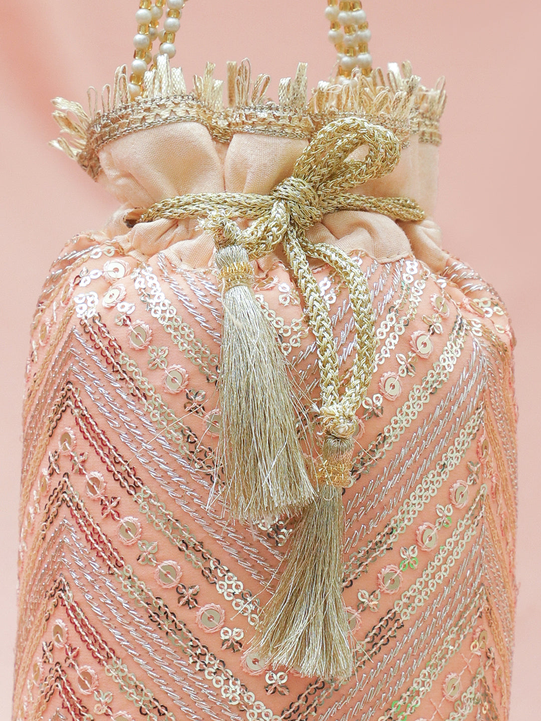 Rubans Peach Pink Sequin Embellished Potli Bag with Pearl Handle & Golden Beaded Tassel Detailing