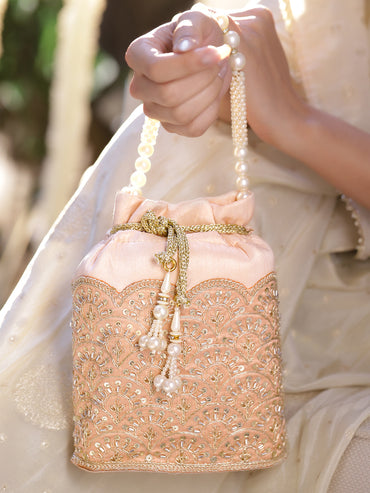 Women Peach Fabric Potli Bag with Golden Embroidery, White Stones & Pearl Tassel Handle