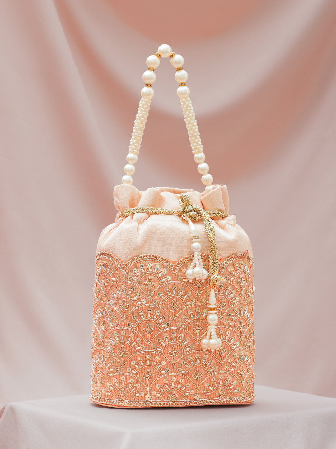 Women Peach Fabric Potli Bag with Golden Embroidery, White Stones & Pearl Tassel Handle