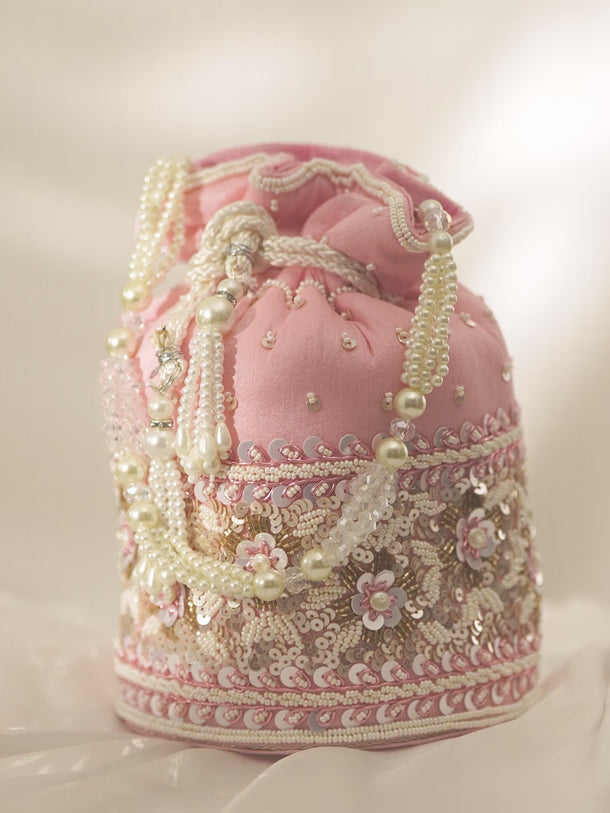 Rubans Pink Coloured Potli Bag With Golden And White Embroided Design.