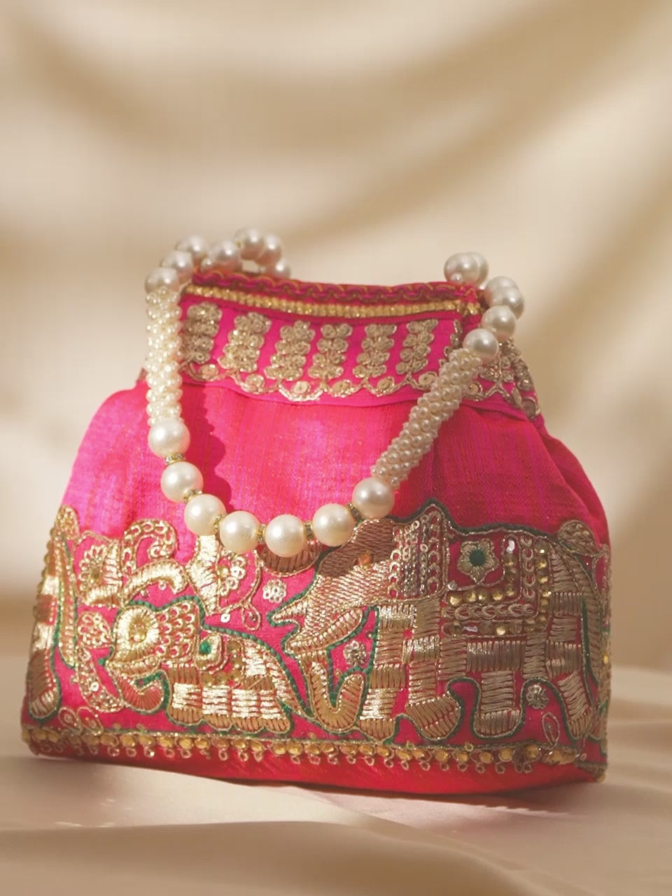 Rubans Pink Silk Potli Bag with Pearl Handle and Intricate Elephant Motif Embroidery