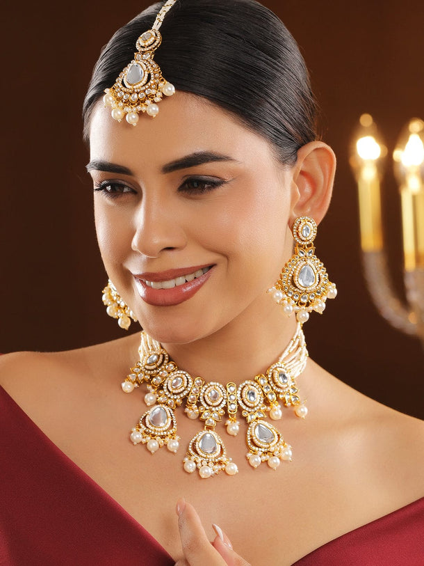 Rubans 22K Gold-Plated Handcrafted White Kundan Studded & Pearl Beaded Bridal Jewellery Set with Earrings & Maangtikka Necklace Sets