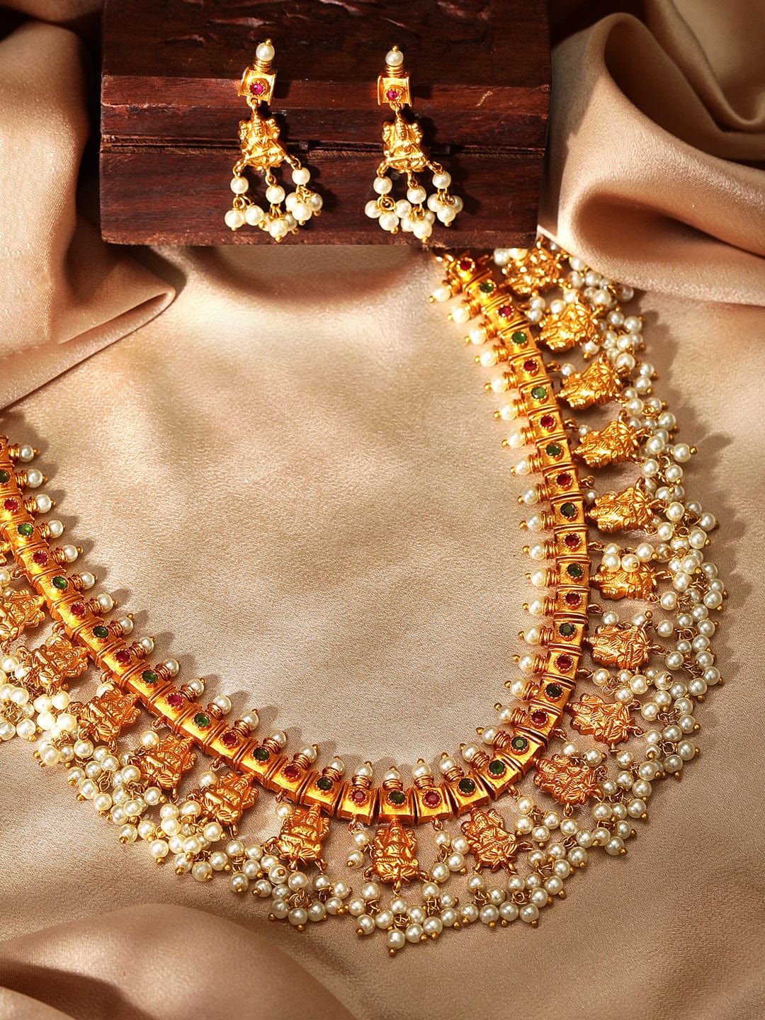 Rubans Finely Handcrafted Gold Plated Faux Ruby Studded Pearl Embellished Necklace Set Necklace Set