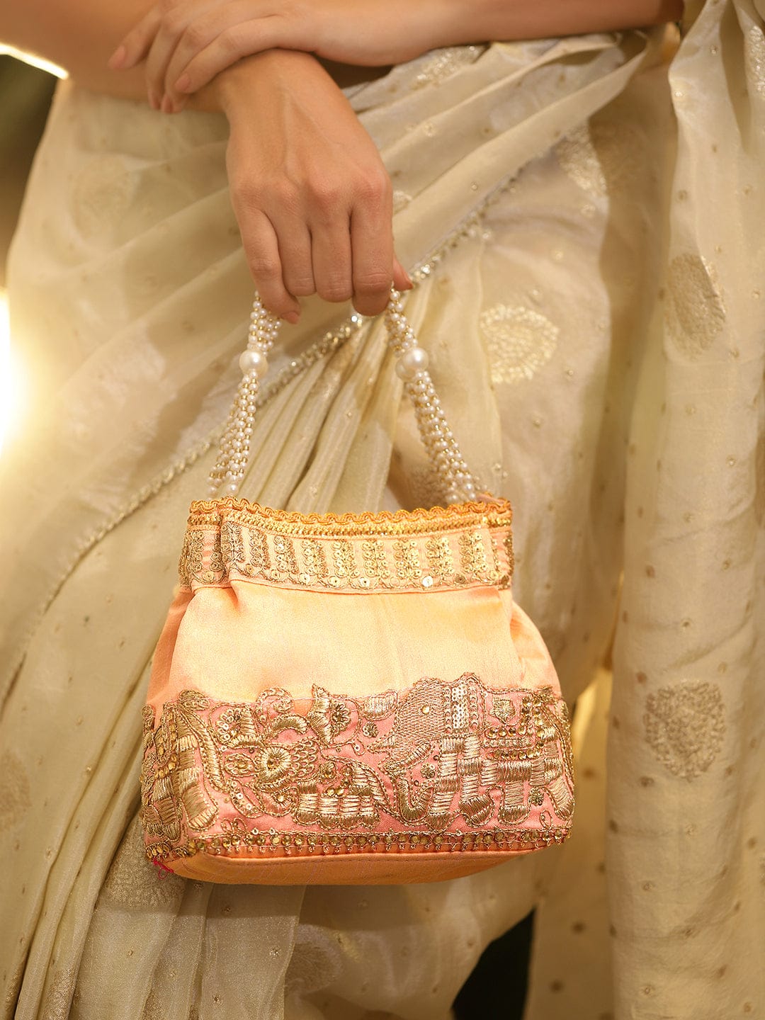 Rubans Handcrafted Peach Pink Silk Potli Bag with Pearl Handle & Gold Embroidered Elephant Motif Bags