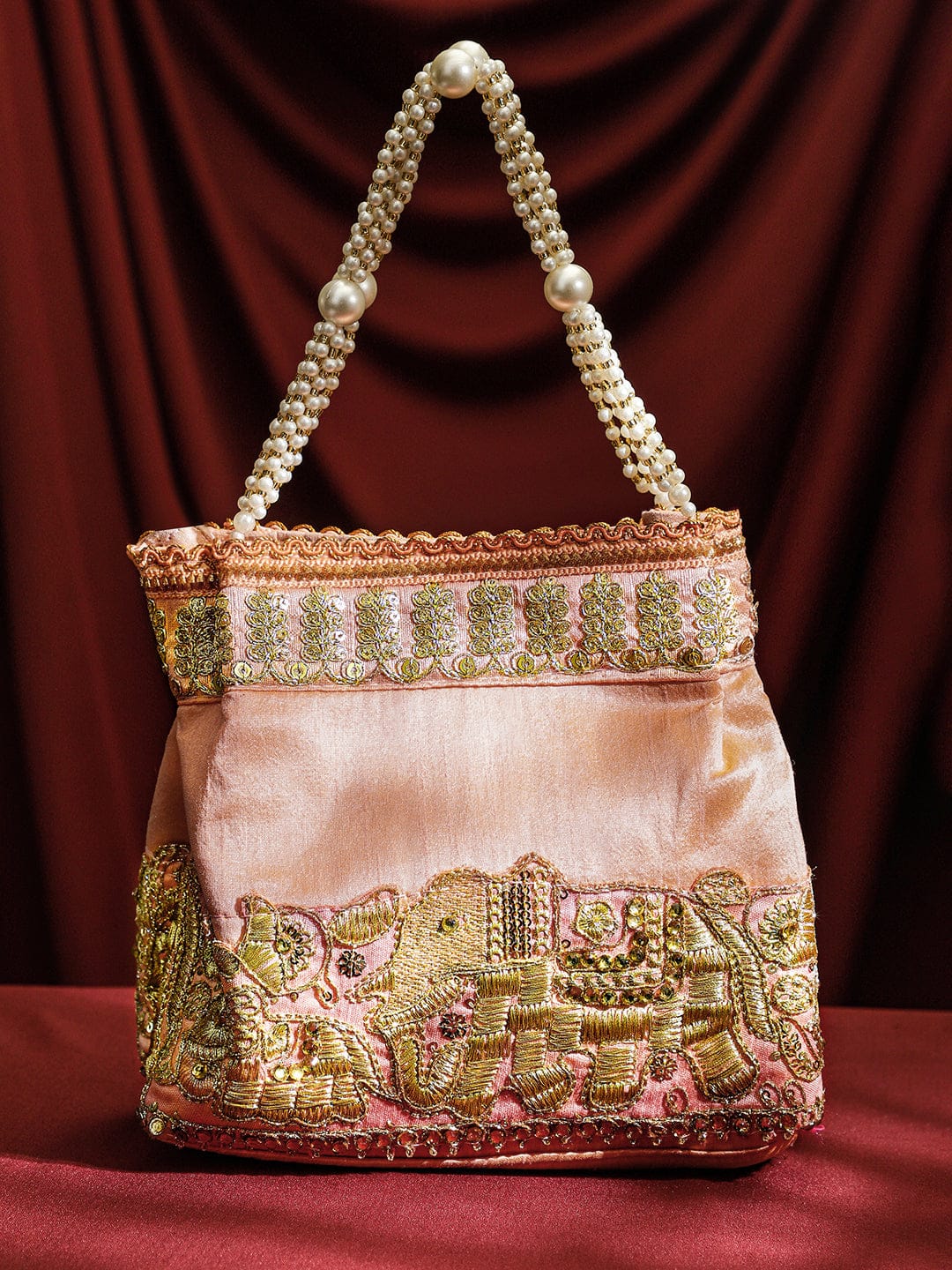 Rubans Handcrafted Peach Pink Silk Potli Bag with Pearl Handle & Gold Embroidered Elephant Motif Bags