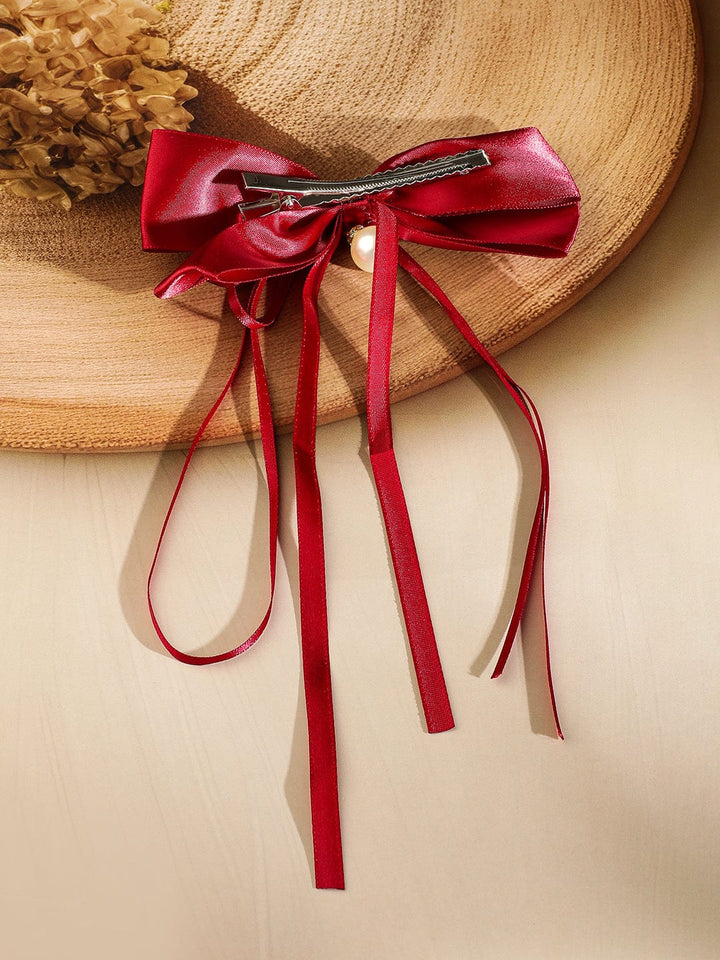 Rubans Red Satin Bow Hair Clip with Pearl Drop & Flowing Ribbon Tails â€“ Elegant & Chic Hair Accessory