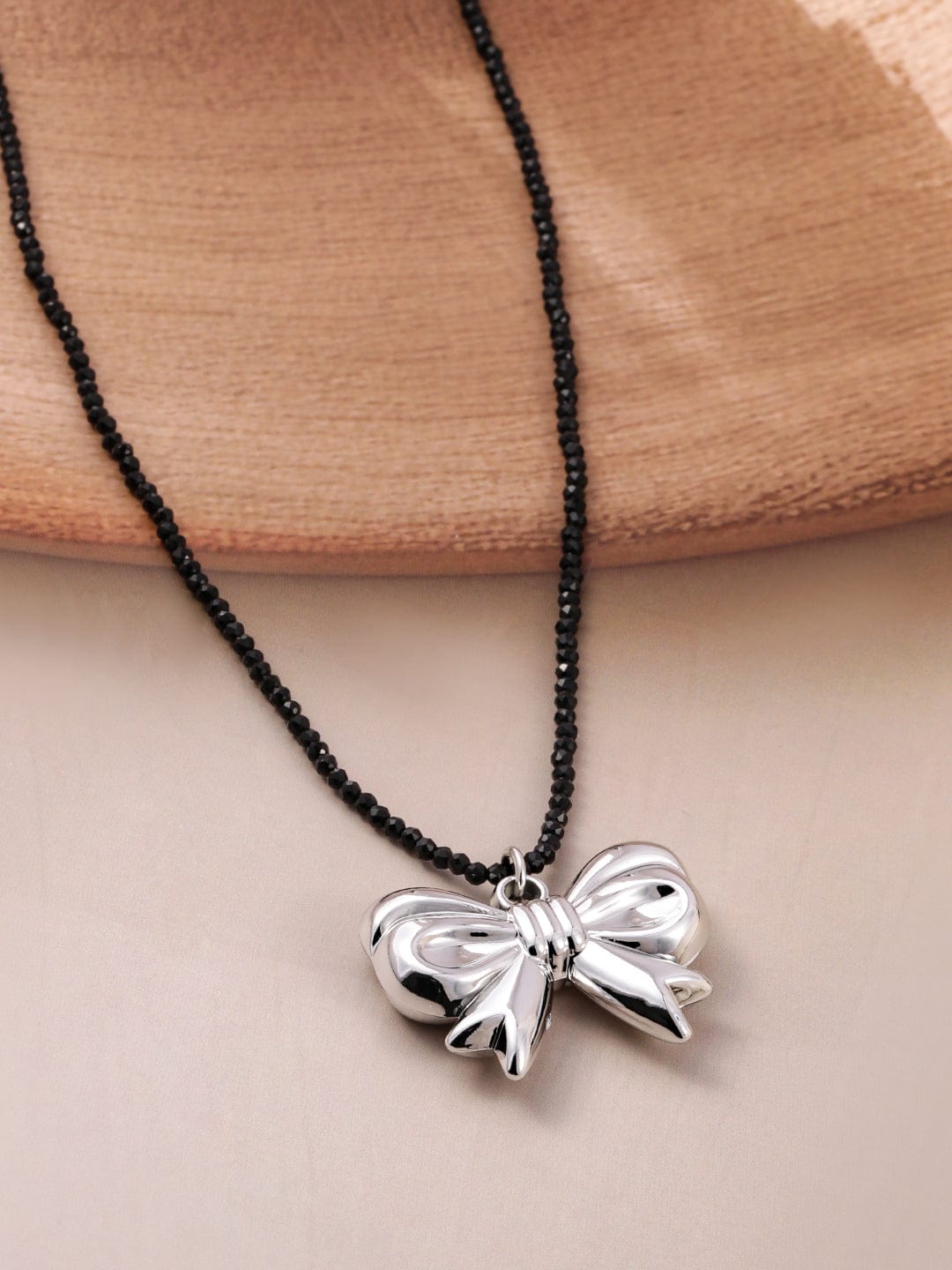 Rubans Voguish Rubans Rhodium Plated Black Beaded Necklace with Silver Bow Pendant