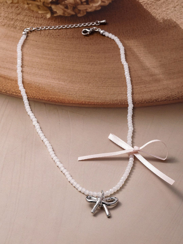 Silver Bow Pendant on Cream Colored Beaded Chain Necklace