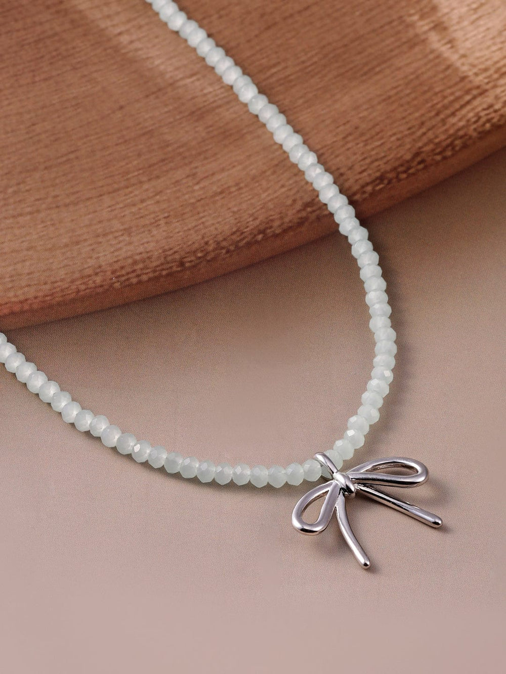 Silver Bow Pendant with White Bead Necklace Necklace