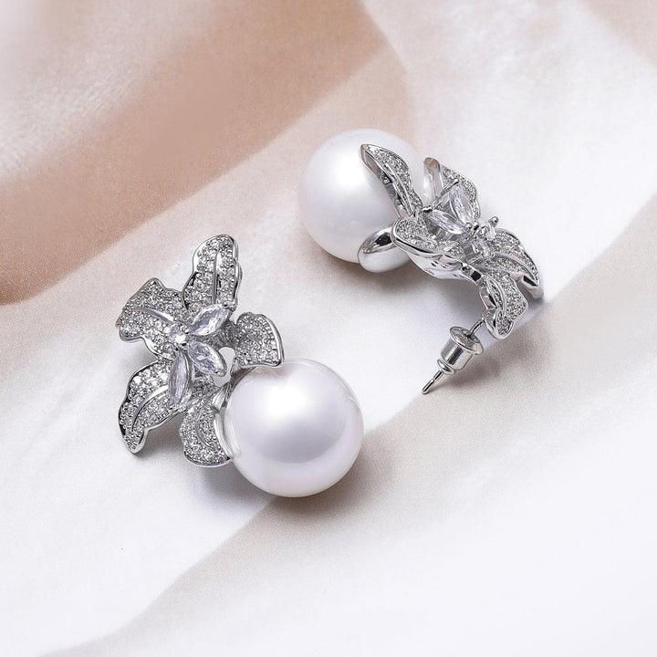 Voguish Rhodium Plated Sparkling AD & Cubic Zirconia Studded Floral Motif Pearl Drop Earrings Earrings