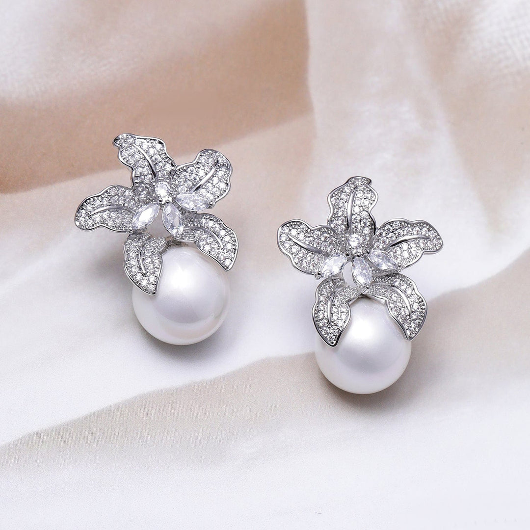 Voguish Rhodium Plated Sparkling AD & Cubic Zirconia Studded Floral Motif Pearl Drop Earrings Earrings